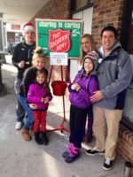 Jon and family ringing the bell for the Salvation Army.